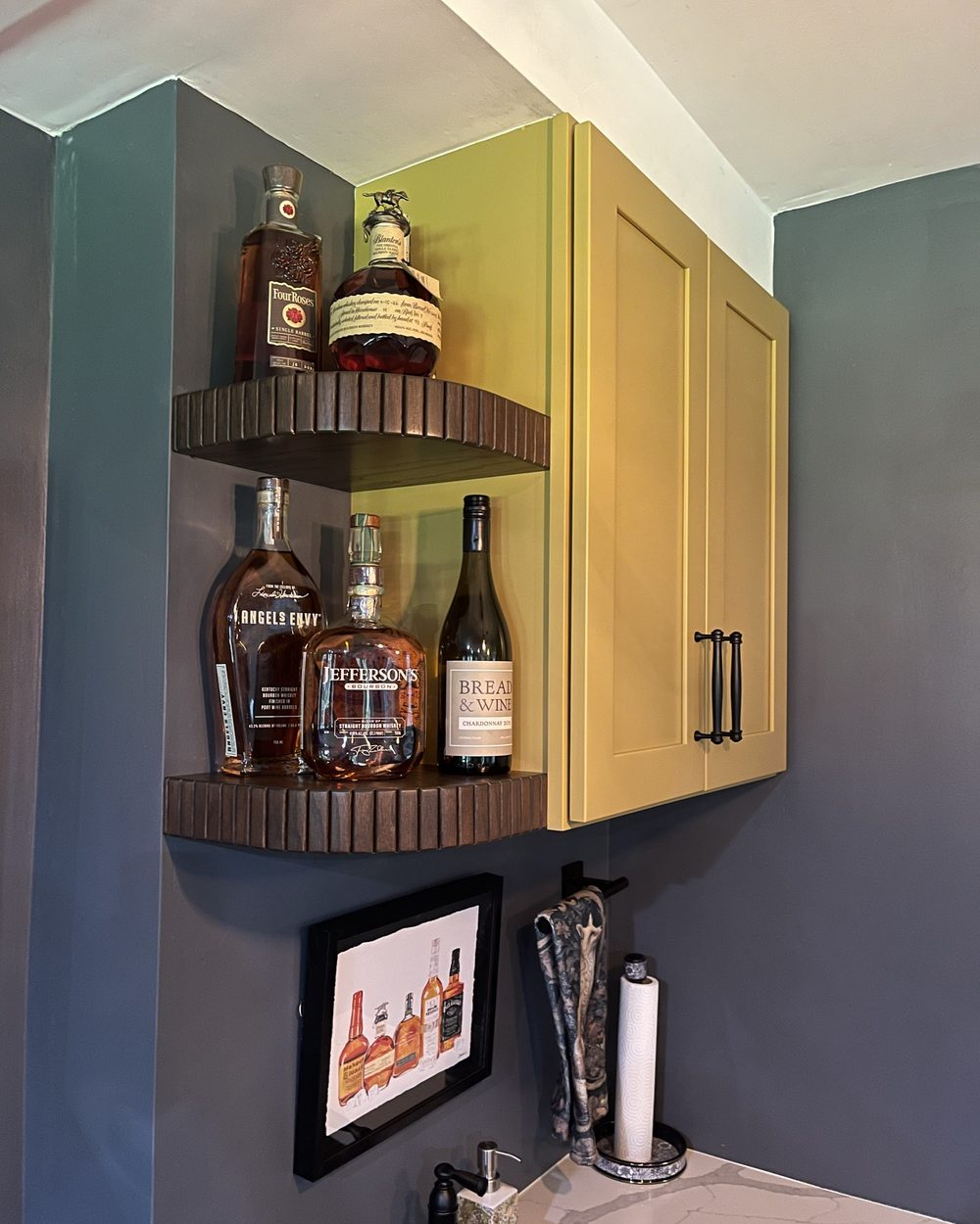 Fluted corner shelves above the bar with bottles displayed