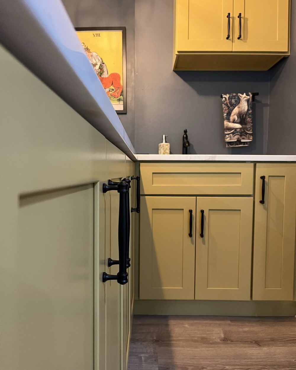 Mustard yellow refinished cabinets with black hardware