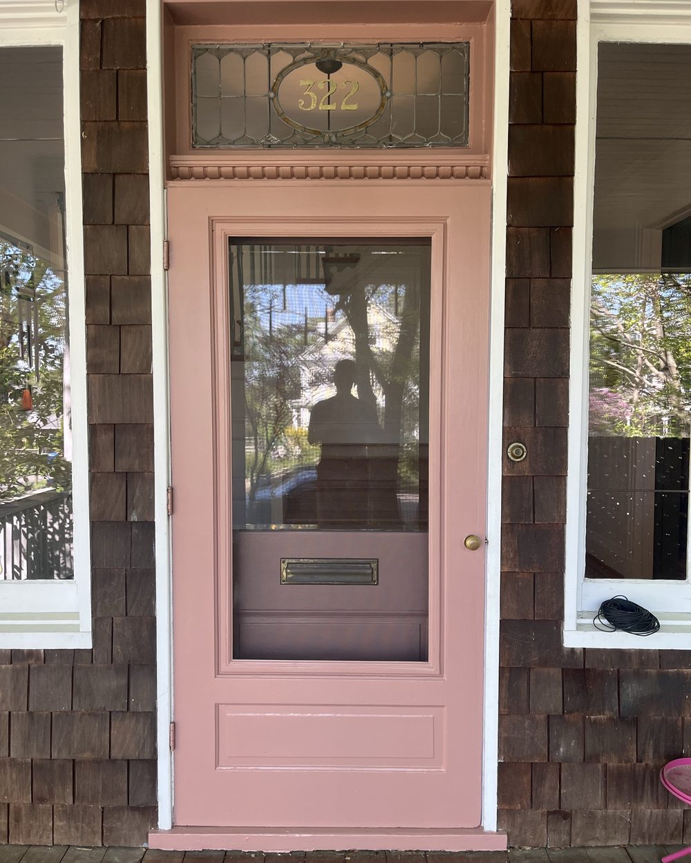 The same entry door restored and painted dusty rose