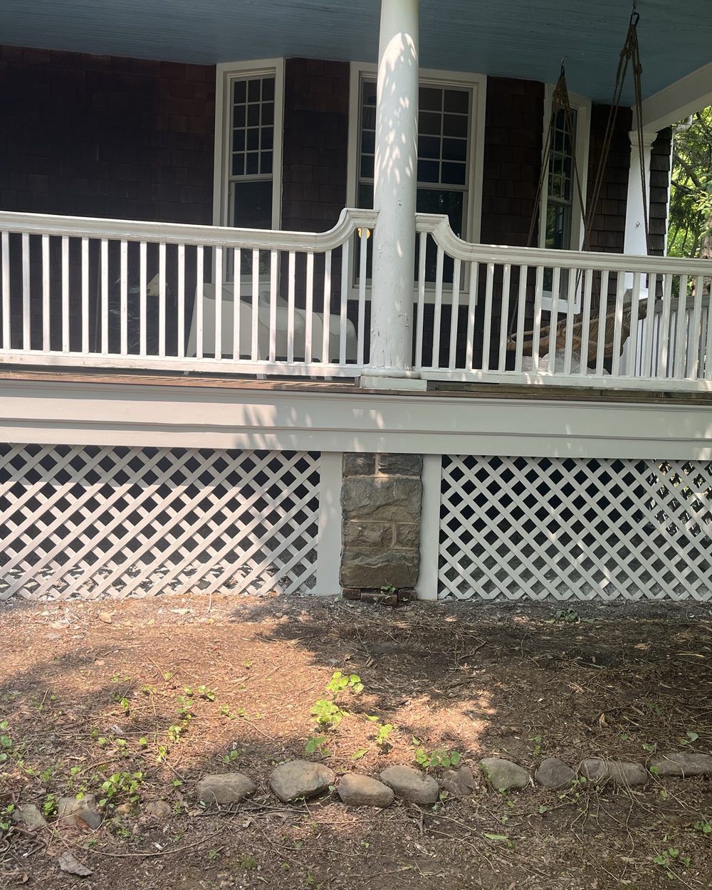 The same porch with new railing and lattice skirting