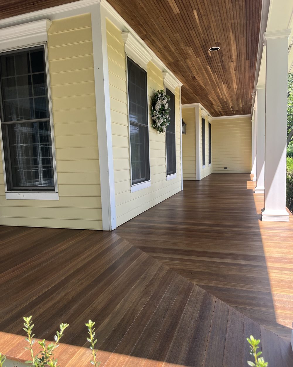 Wrap-around porch with tongue-and-groove ceiling and wood decking