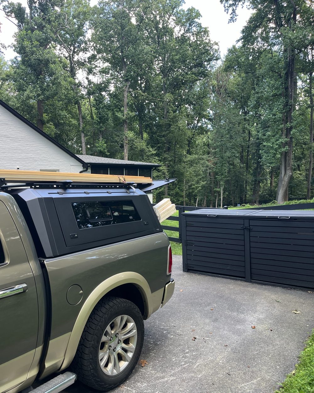 Enclosure at the head of a driveway next to a truck