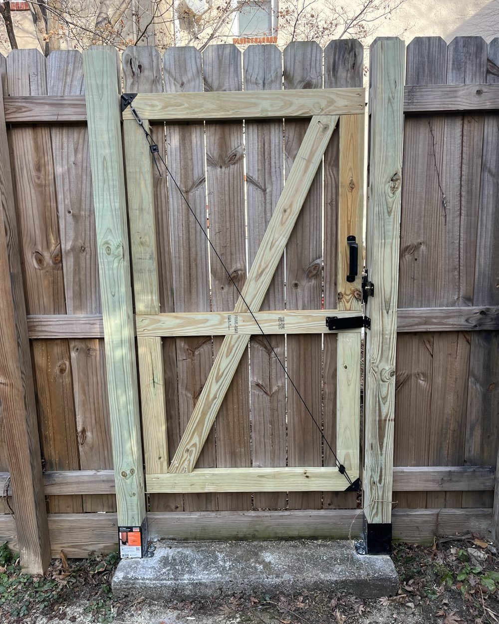 Custom built wooden gate set into a fence