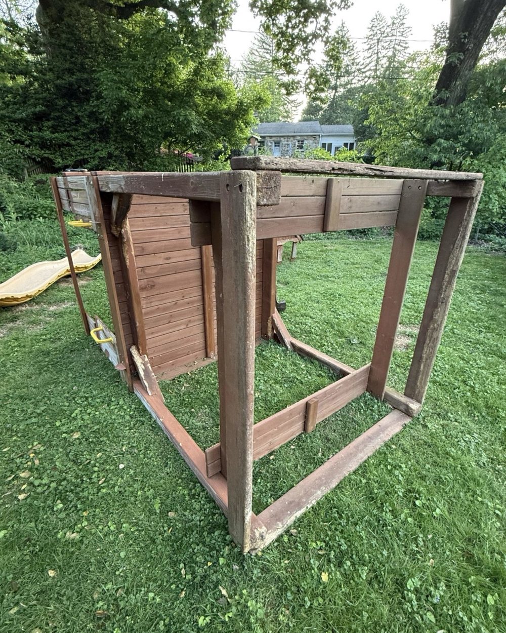 Playset stripped down to its bare frame on the lawn