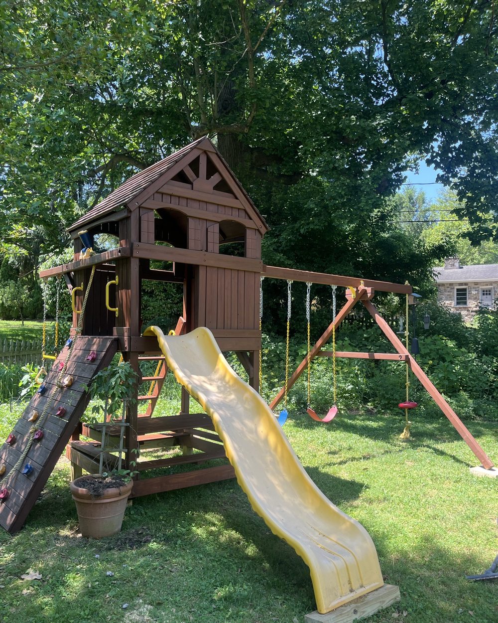 The rebuilt playset with roof, slide and swings