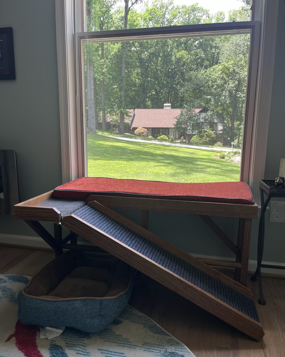 Custom upholstered window bench with a wood ramp