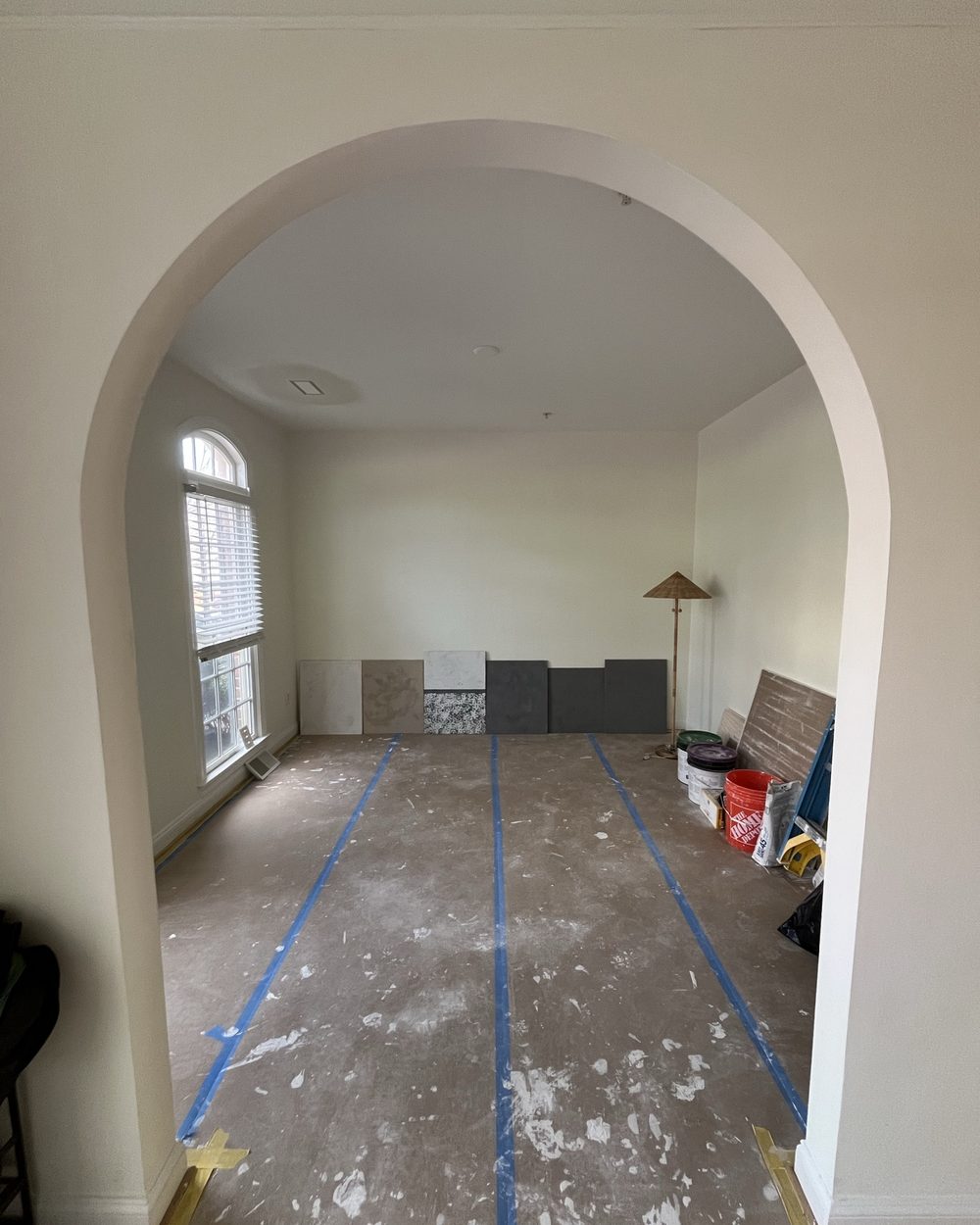 Arched living room opening prepped and masked for paint